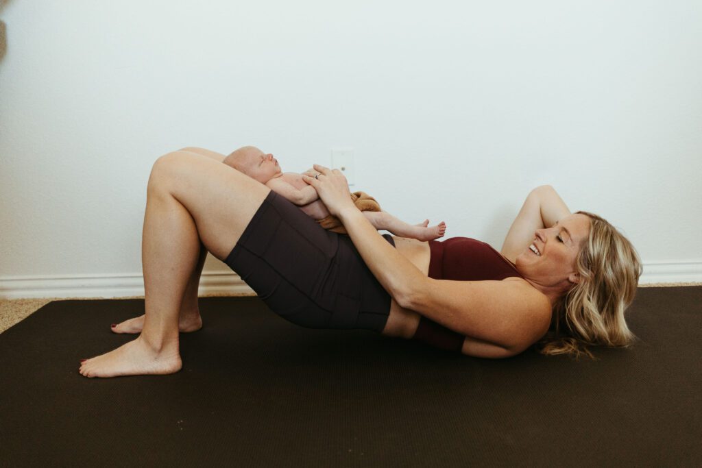 a mom doing postpartum pelvic floor exercises with her baby.