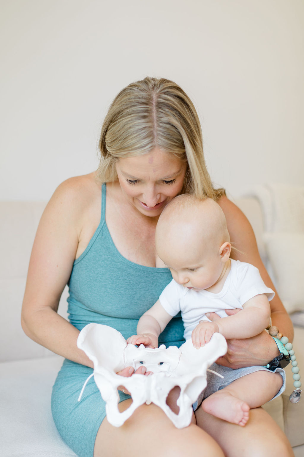 Pelvic floor PT holding pelvic floor and baby.