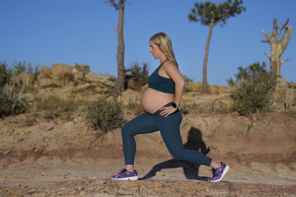 Pregnant woman warming up before running. 