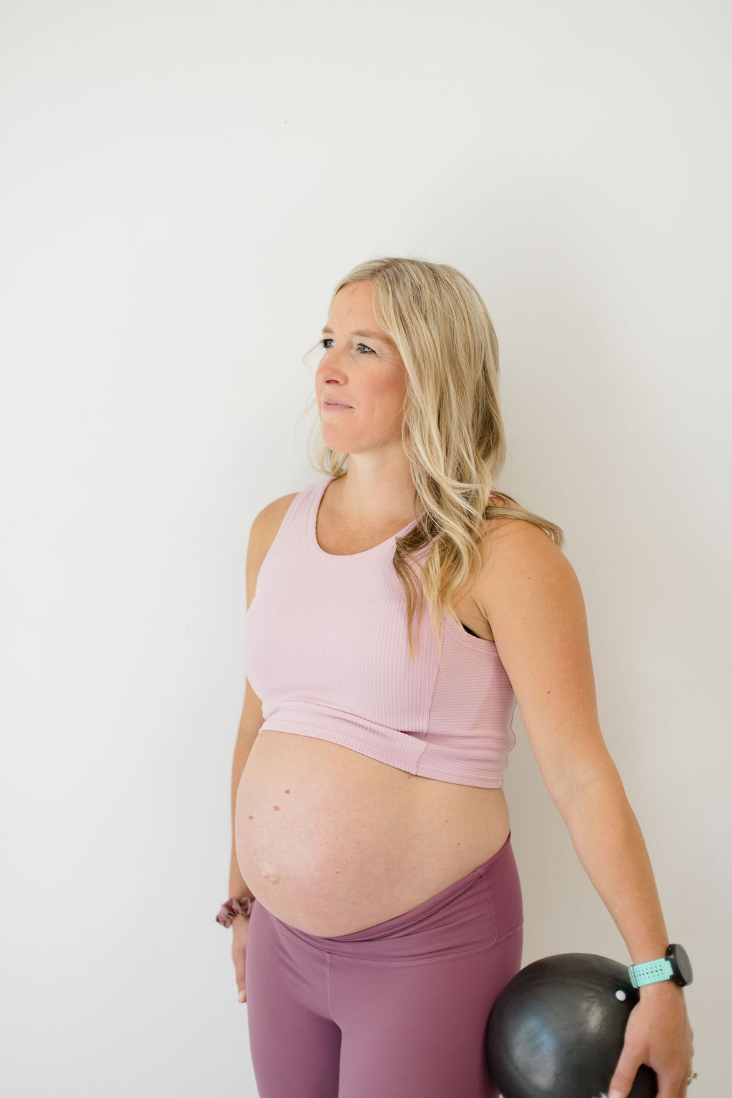 Pelvic floor physical therapist holding a black exercise ball.